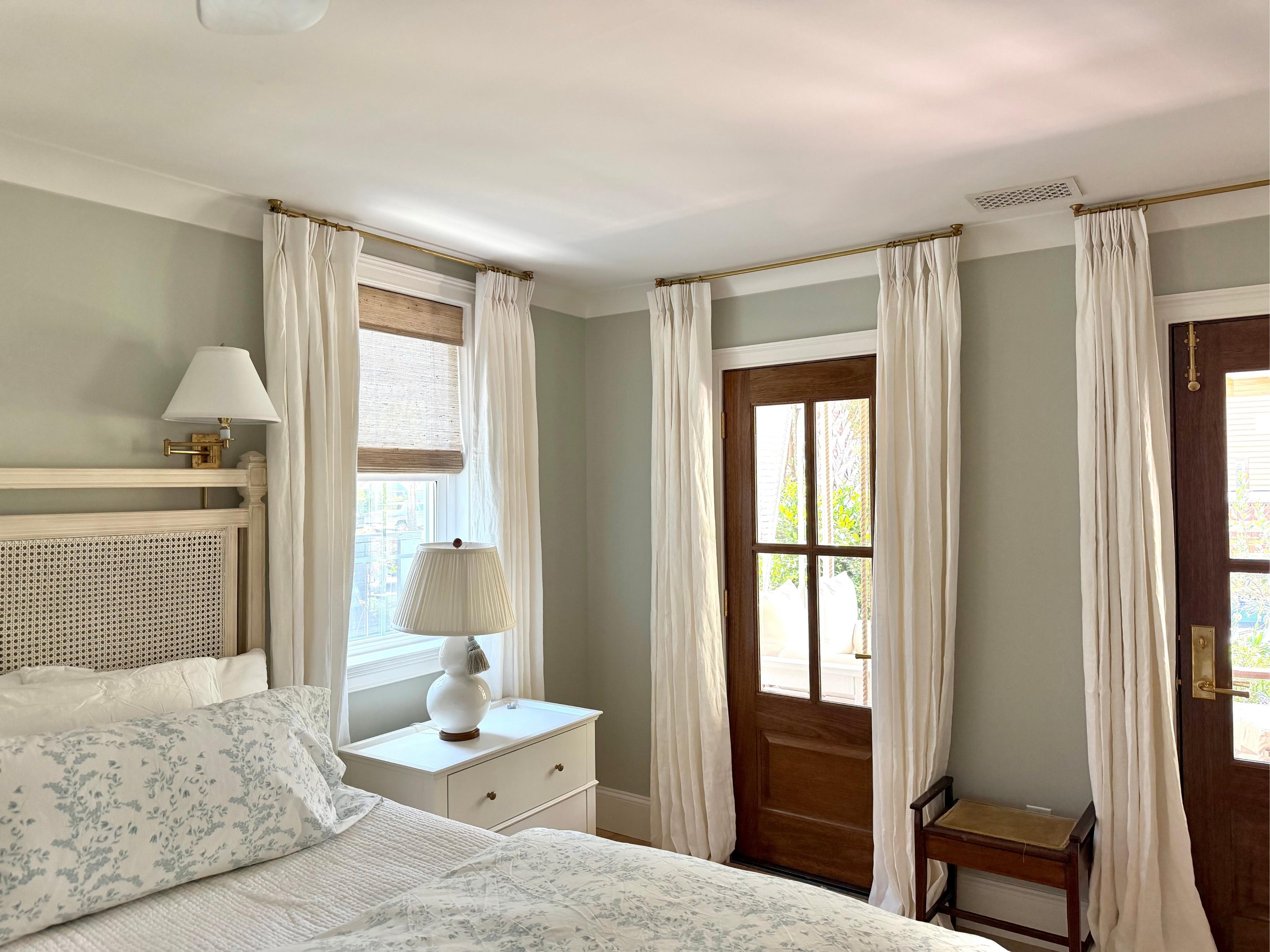 DIY ceiling curtain rod with linen drapes, designed to work around crown molding
